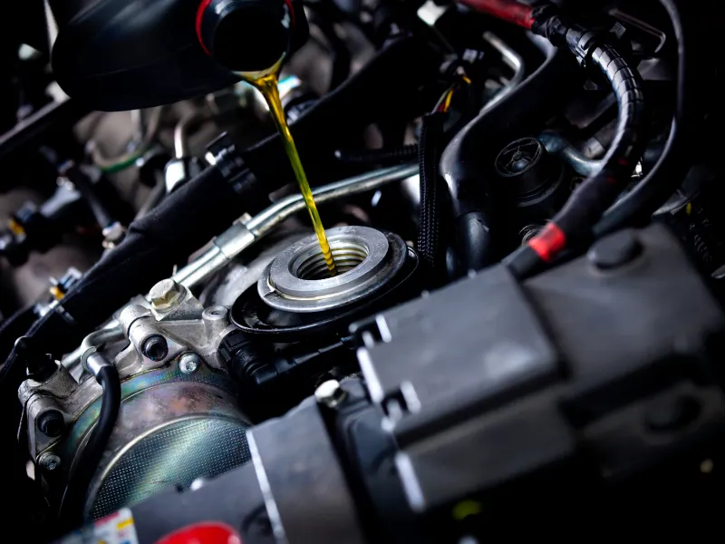 Technician performing European car oil change